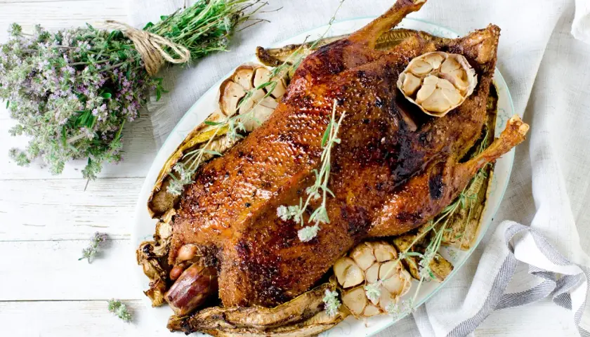 Pieczona kaczka z czosnkiem i ziołami. Idealne jakie przyprawy do kaczki? Tymianek i czosnek nadają jej wspaniały aromat.