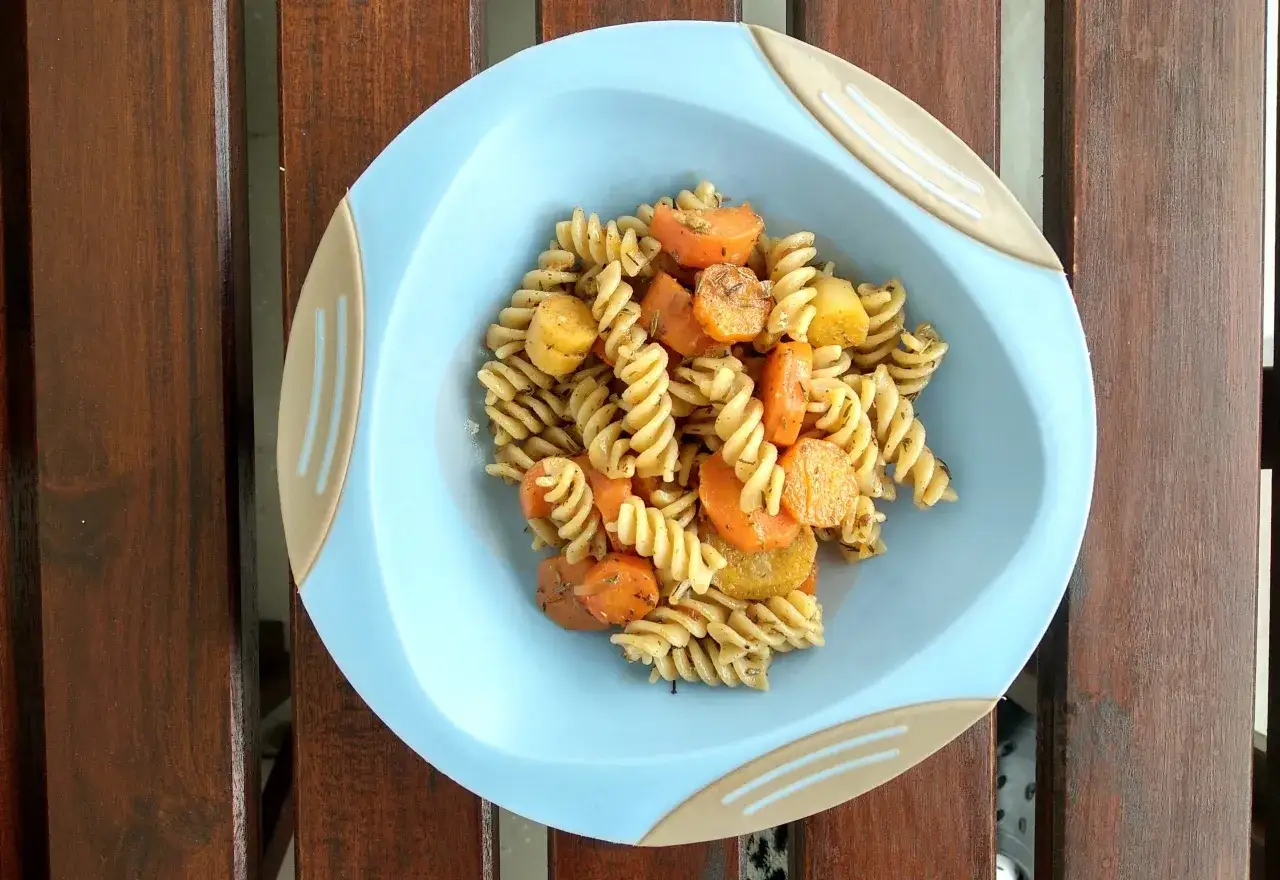 Szybki obiad dla dzieci: makaron fusilli z pieczoną marchewką i ziemniakami, doprawiony ziołami.