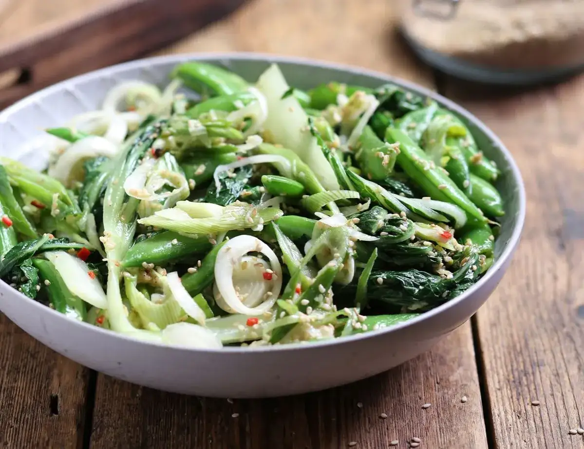 Sałatka z pak choi, groszku cukrowego i cebuli dymki, posypana sezamem. Idealna do dań kuchni azjatyckiej, świetne kapusta pak choi przepisy.